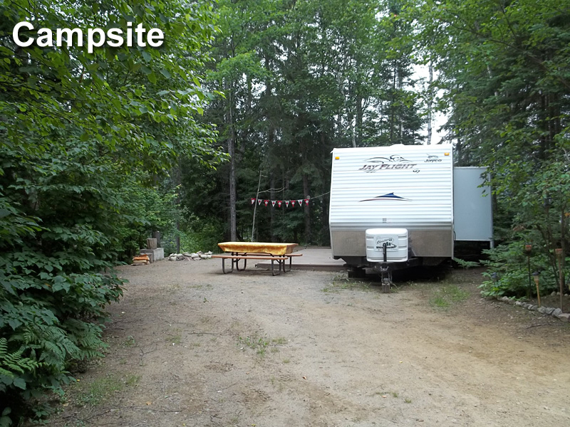 This is a photo of a house trailer and a picnic table